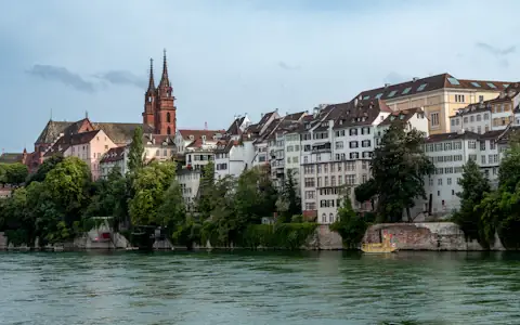 Calm river flowing past a historic European city on a clear day