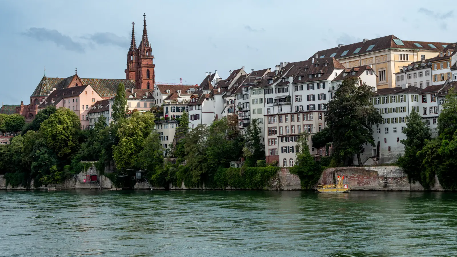 Calm river flowing past a historic European city on a clear day