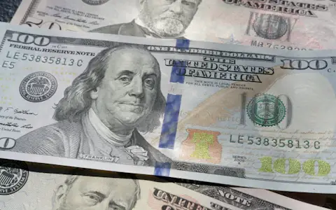 Close-up of a US hundred dollar bill, the dollar backing new stablecoins like PYUSD and RLUSD
