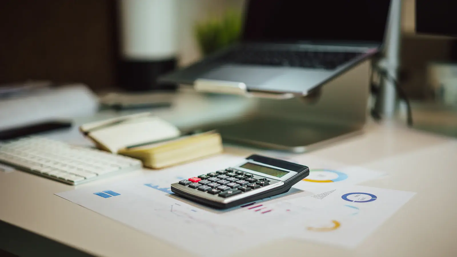 Calculator beside a laptop on a desk, ready for working out crypto tax across countries