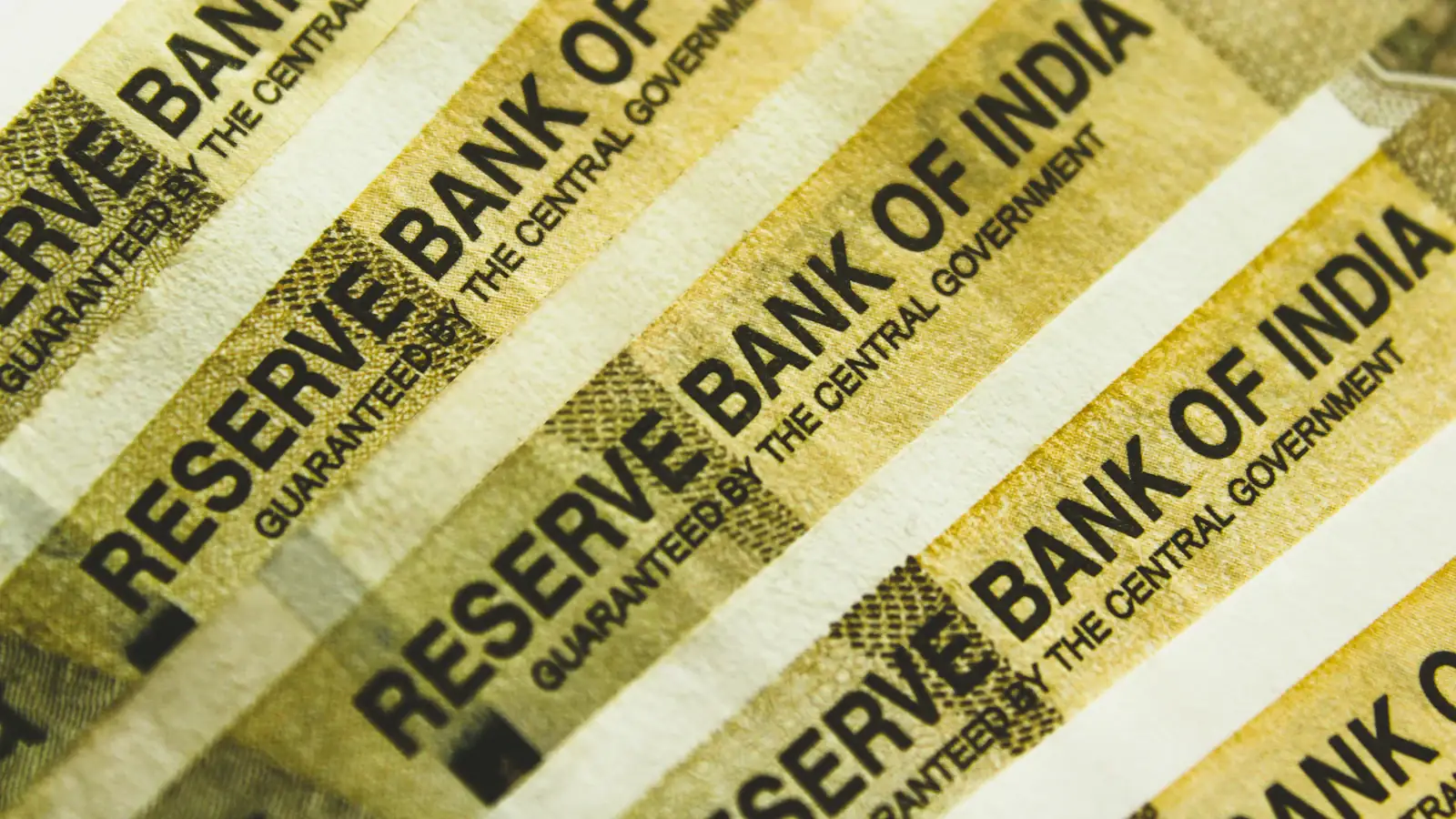 Stack of Indian rupee banknotes in warm light, the cash that India's digital rupee complements