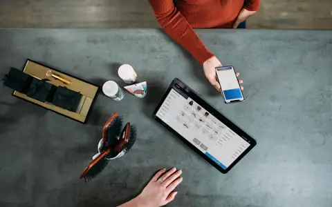 Overhead view of a customer paying with a smartphone digital wallet at a counter