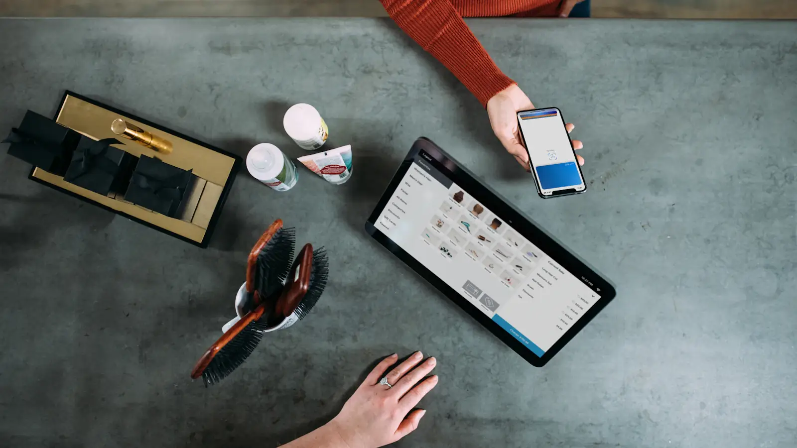 Overhead view of a customer paying with a smartphone digital wallet at a counter
