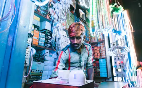 Street vendor selling assorted lights at a market stall in India