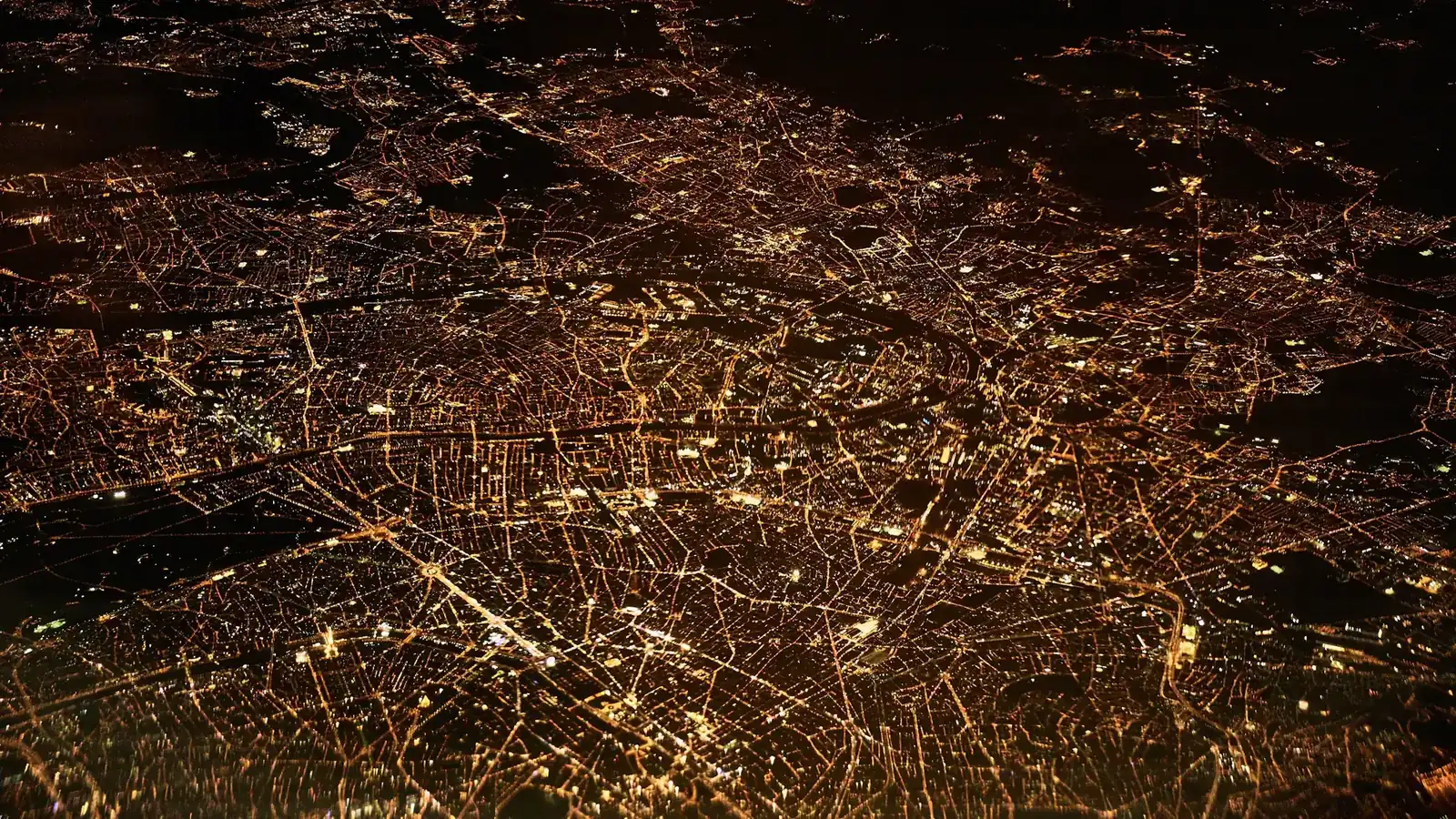 Aerial night view of glowing city light networks, evoking global payment rails like Ripple