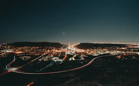 Aerial view of a city grid glowing at night, suggesting interconnected blockchain payment networks