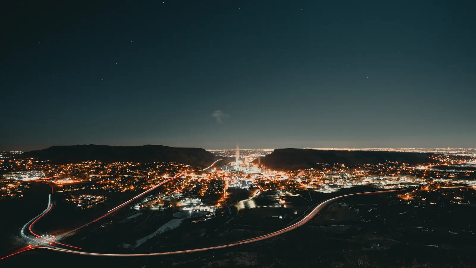 Aerial view of a city grid glowing at night, suggesting interconnected blockchain payment networks