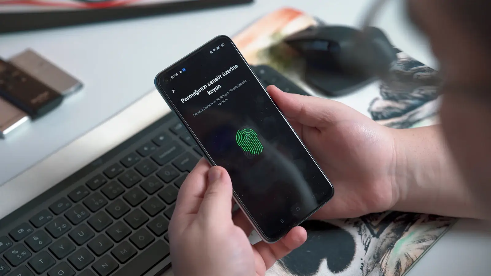 Person using the fingerprint sensor on a smartphone, the passkey-style security of self-custody wallets