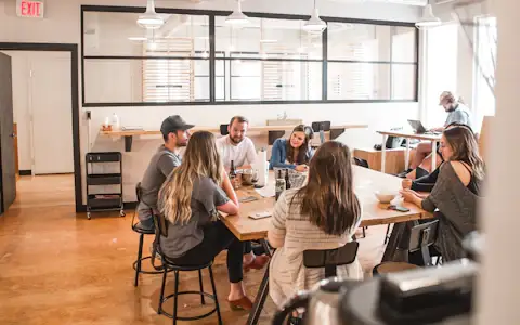 Founders and investors talking around a table during a collaborative startup funding meeting