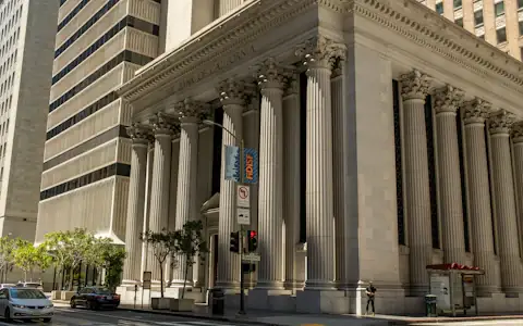 Neoclassical bank building with tall columns lining a city street