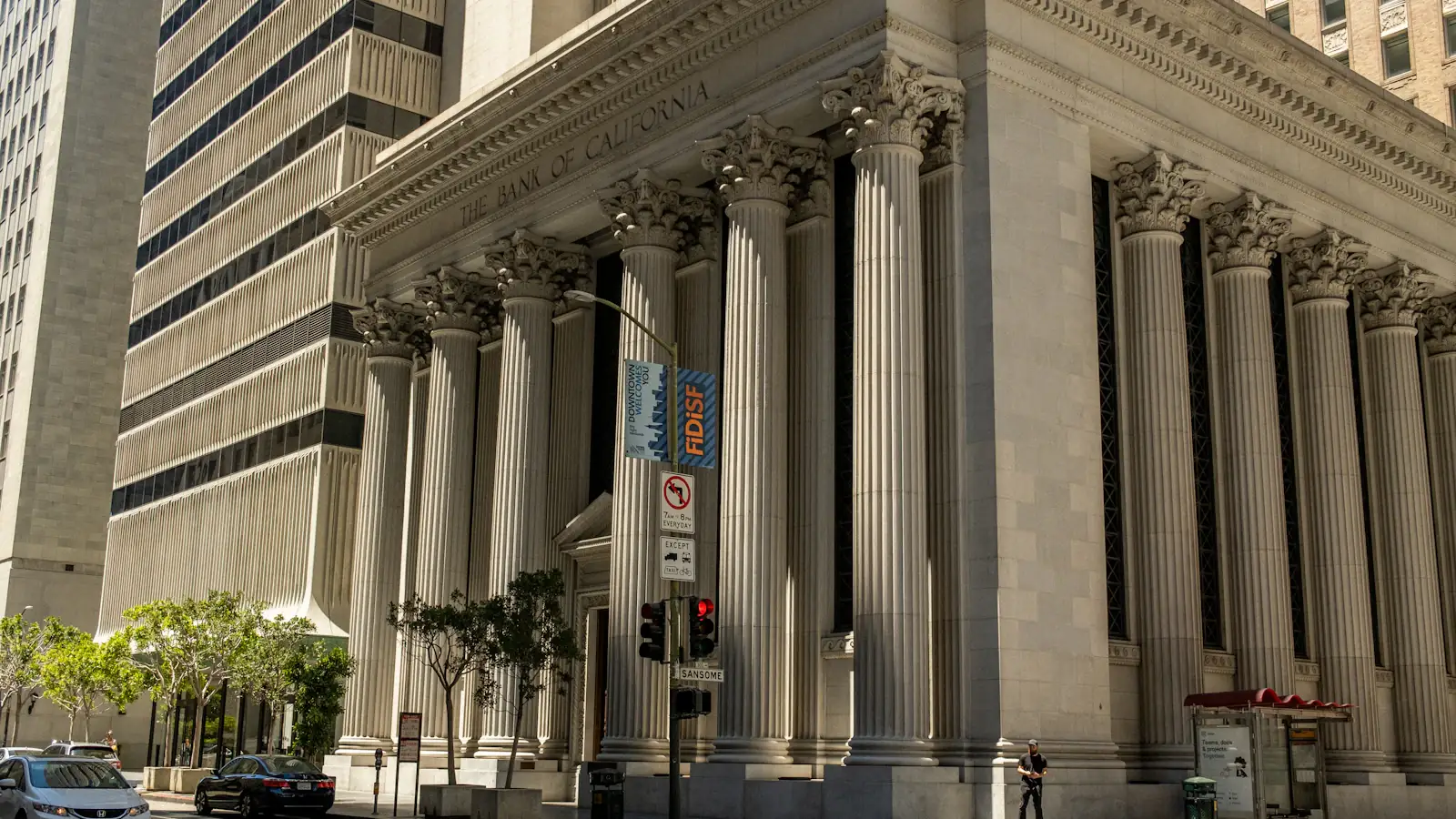 Neoclassical bank building with tall columns lining a city street
