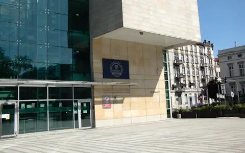 Modern glass and stone bank headquarters building on a bright day