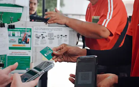 Customer paying with a smartphone at a checkout counter, a moment UPI aims to own globally