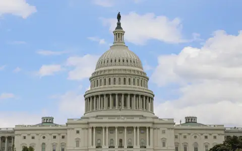 United States Capitol building under a bright blue sky, where crypto market structure law is written