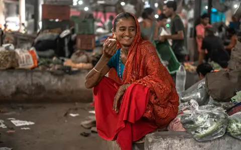 Indian woman talking on her mobile phone, keeping in touch with family abroad